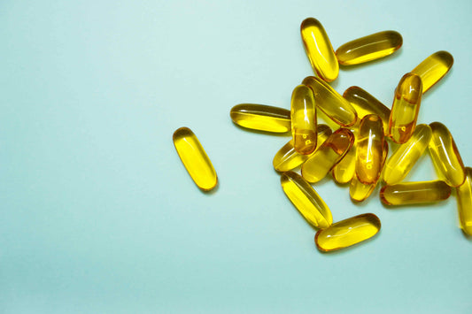 Fish oil supplements on blue background